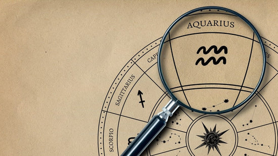 The imprint of the zodiac sign Aquarius on old paper is enlarged with a lens