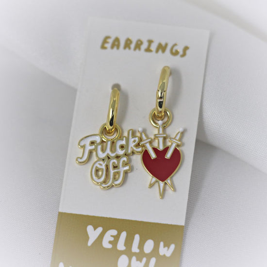 Yellow Owl Workshop Earrings - Mismatched hanging charms. One says Fuck Off and the other is a heart pierced by three swords.