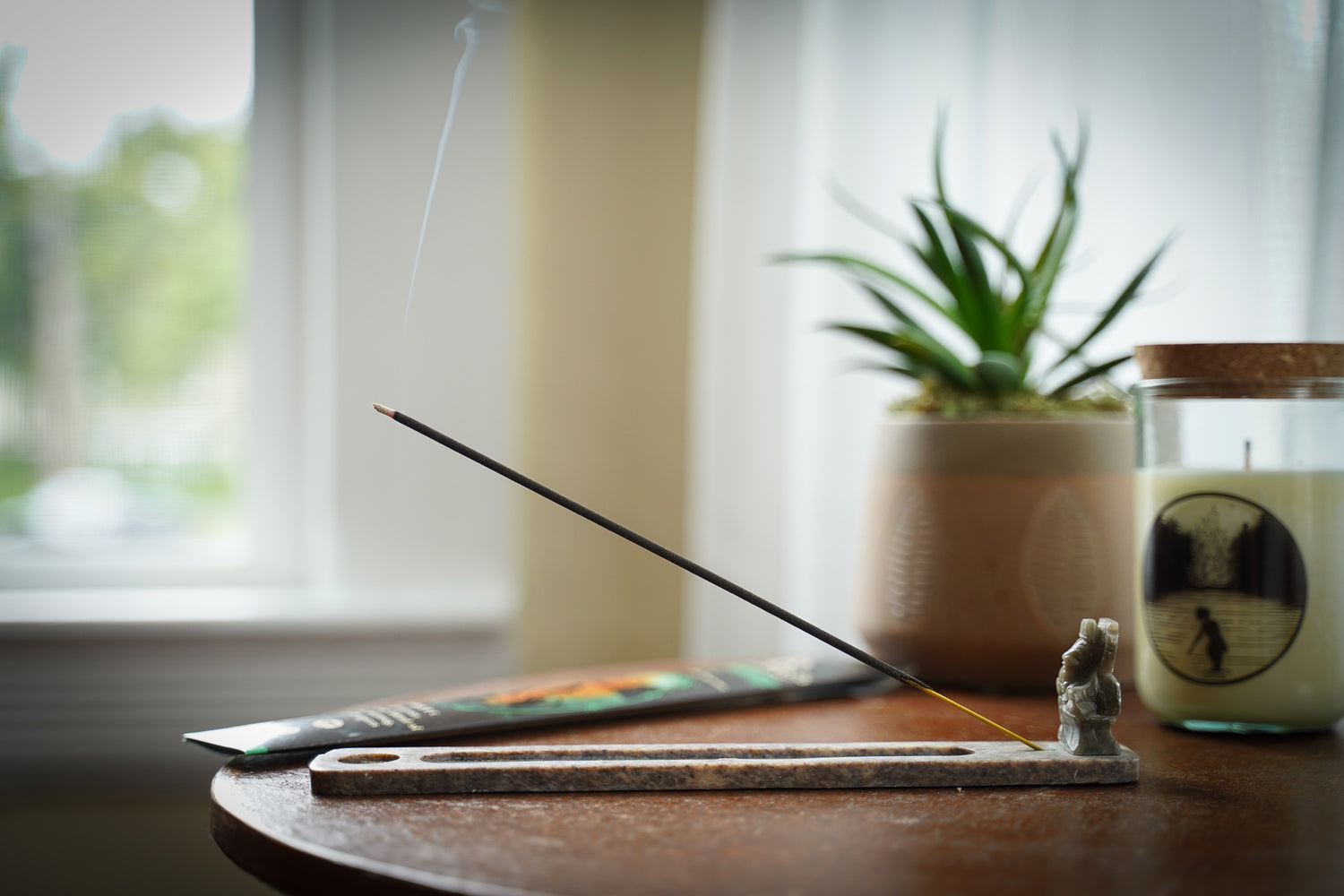 Stick incense burning on a coffee table