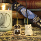 Brown and White handmade clay owl incense holders with White Lodge products out of focus in the background.