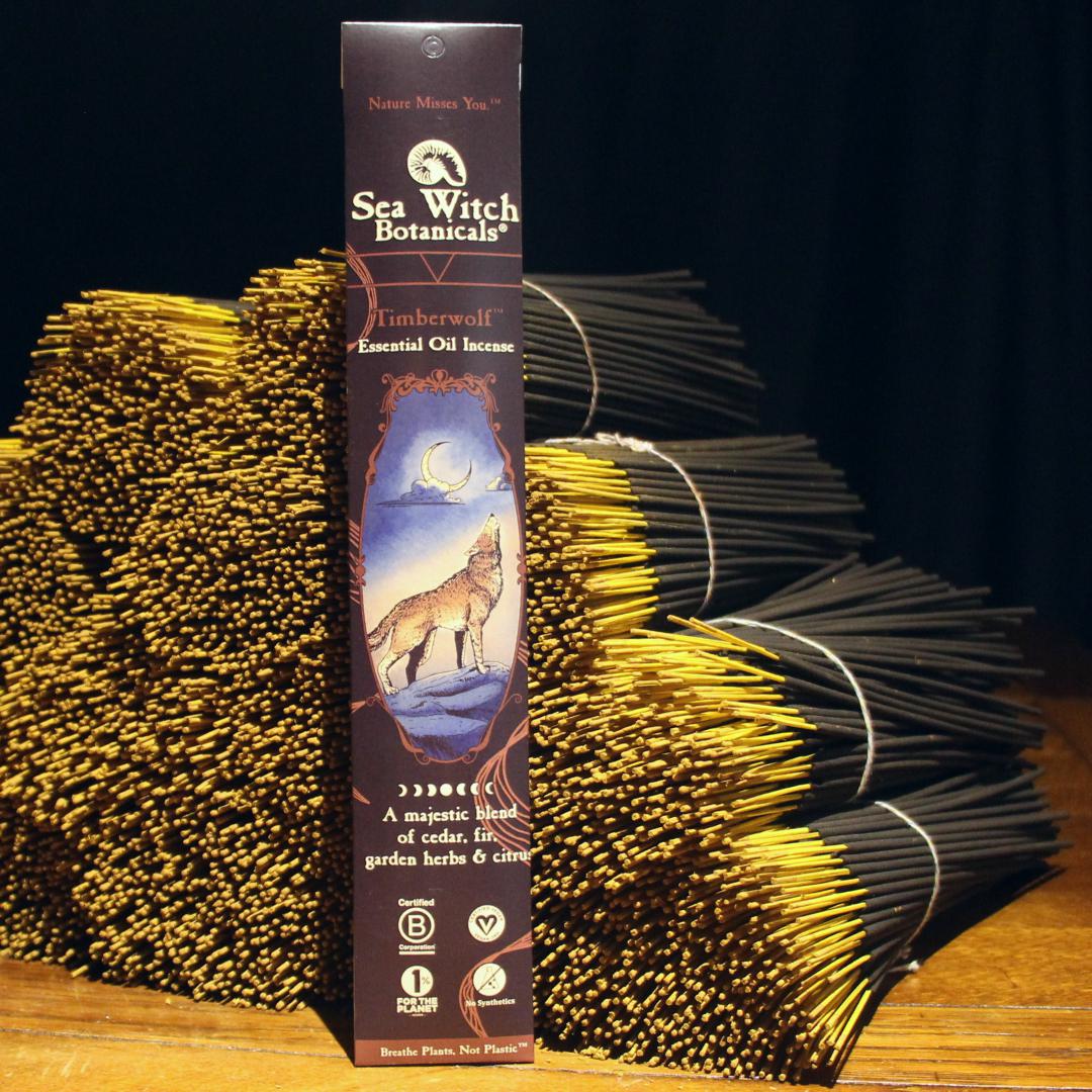 A 20 pack of Timberwolf essential oil incense is posed against a stack of bundled Timberwolf incense sticks.