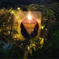 8oz Krampus soy wax candle burning amongst conifer boughs