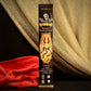limited edition 2022 krampus essential oil incense on a black set with red and gold fabrics in the background