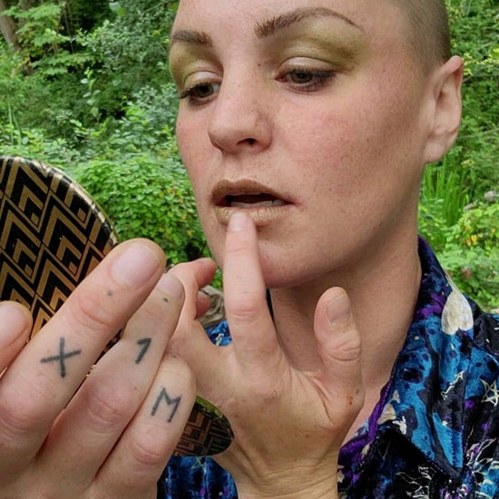 Model applying Moss vegan lip tint